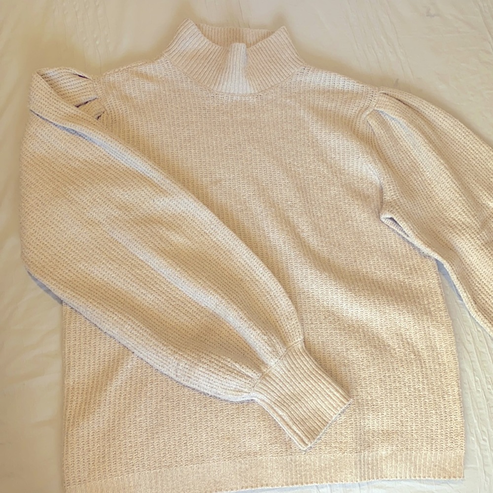 Light Tan, low turtleneck Sweater.
